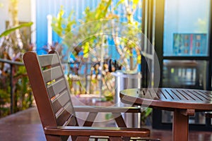 Outdoor patio chair and table. Outdoor wooden patio chair and table with sun light