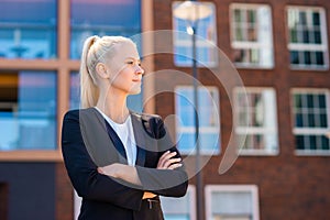 Outdoor photo of young and attractive businesswoman, retailer or student. Woman in casual wear. Real estate, business