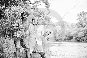 outdoor picnic. summer family weekend. father and son fishing. mature man fisher celebrate retirement. two fishermen