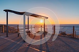 Outdoor picnic table on the beach at sunset