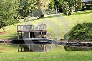 Outdoor platform and table overlooking a dam on a luxury country estate