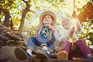 Outdoor play is important to a childs development. two little children playing together outdoors.