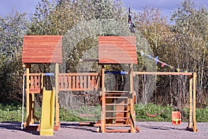 Outdoor playset for toddlers and kids made of wood and plastic. photo