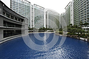 Outdoor pool and trees in between residential condominiums
