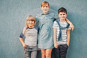Outdoor portrait of 3 fashion kids