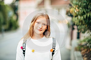 Outdoor portrait of adorable 10-12 year old girl