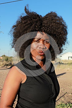 Outdoor portrait of a beautiful african woman pouting