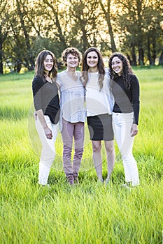 Outdoor Portrait of a beautiful family, a mother and her daughters