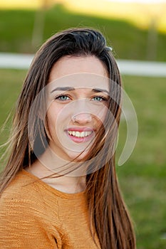 Outdoor portrait of beautiful happy teenager girl laughing