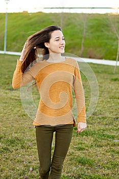 Outdoor portrait of beautiful happy teenager girl laughing