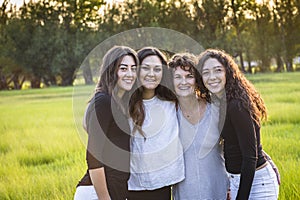 Outdoor Portrait of a beautiful Hispanic family, a mother and her daughters