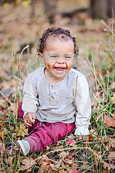 Outdoor Portrait of a beautiful smiling mixed race little boy