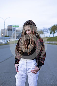outdoor portrait of a beautiful young teen girl feeling sad