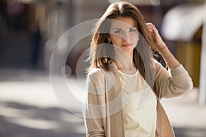 Outdoor portrait of beauty woman with perfect smile standing on the street