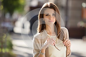 Outdoor portrait of beauty woman with perfect smile standing on the street