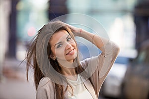 Outdoor portrait of beauty woman with perfect smile walking on the street