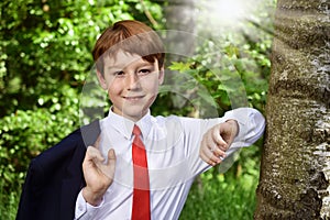 Outdoor portrait of boy going to First Holy Communion