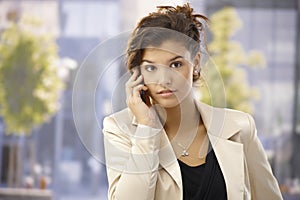 Outdoor portrait of businesswoman with mobile