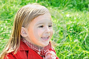 Outdoor portrait of cute laughing little girl