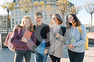 Outdoor portrait of a female teacher and group of teenage students, golden hour