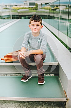 Outdoor portrait of funny little schoolboy