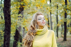 Outdoor portrait Gorgeous brunette model girl with sunny day light. Autumn woman having fun at the park and smiling