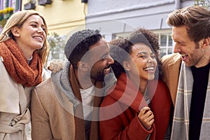 Outdoor Portrait Of Group Of Friends Wearing Coats And Scarves In Autumn Or Fall