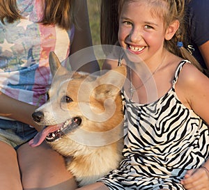 Outdoor portrait of group of teenagers with the dog.