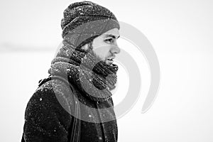 Outdoor portrait of handsome man in gray coat. Fashion photo. Beauty winter snowfall style. Black and White