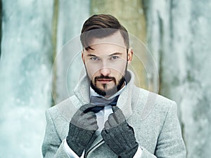 Outdoor portrait of handsome man in gray coat