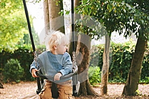 Outdoor portrait of happy and active toddler boy