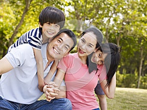 Outdoor portrait of happy asian family