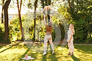 Outdoor portrait of happy family having fun in summer park