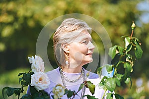 Outdoor portrait of happy and healthy mature 50 - 55 year old woman