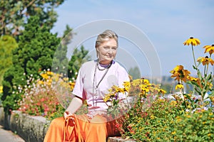 Outdoor portrait of happy and healthy mature 50 - 55 year old woman