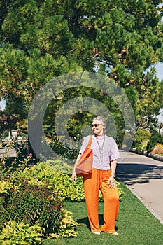 Outdoor portrait of happy and healthy mature 50 - 55 year old woman