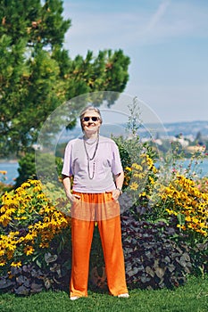 Outdoor portrait of happy and healthy mature 50 - 55 year old woman