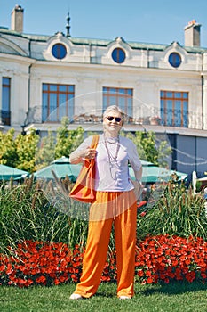 Outdoor portrait of happy and healthy mature 50 - 55 year old woman