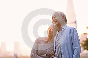 Outdoor portrait of happy senior asian couple