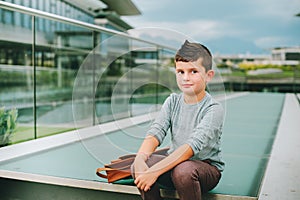 Outdoor portrait of funny little schoolboy