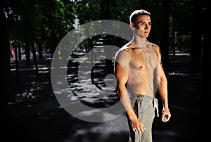 Outdoor portrait of healthy handsome active man with fit muscular body, sports and fitness concept