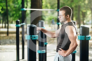 Outdoor portrait of healthy handsome active man with fit muscular body, sports and fitness concept