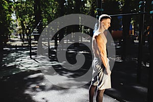 Outdoor portrait of healthy handsome active man with fit muscular body, sports and fitness concept