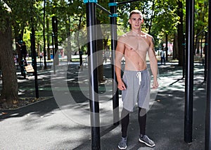 Outdoor portrait of healthy handsome active man with fit muscular body, sports and fitness concept