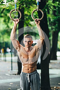 Outdoor portrait of healthy handsome active man with fit muscular body, sports and fitness concept