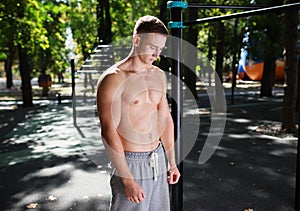 Outdoor portrait of healthy handsome active man with fit muscular body, sports and fitness concept