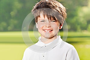 Outdoor portrait of joyful ten years old boy