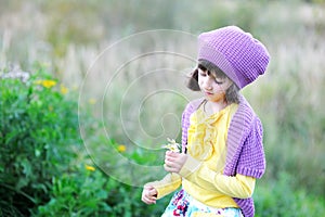 Outdoor portrait of little girl with flowers