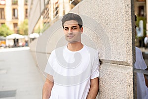 Outdoor portrait of modern attractive young man in the city. Urban background