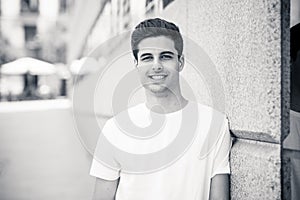 Outdoor portrait of modern attractive young man in the city. Urban background